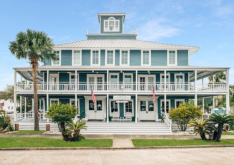 a building with palm trees in front Next
