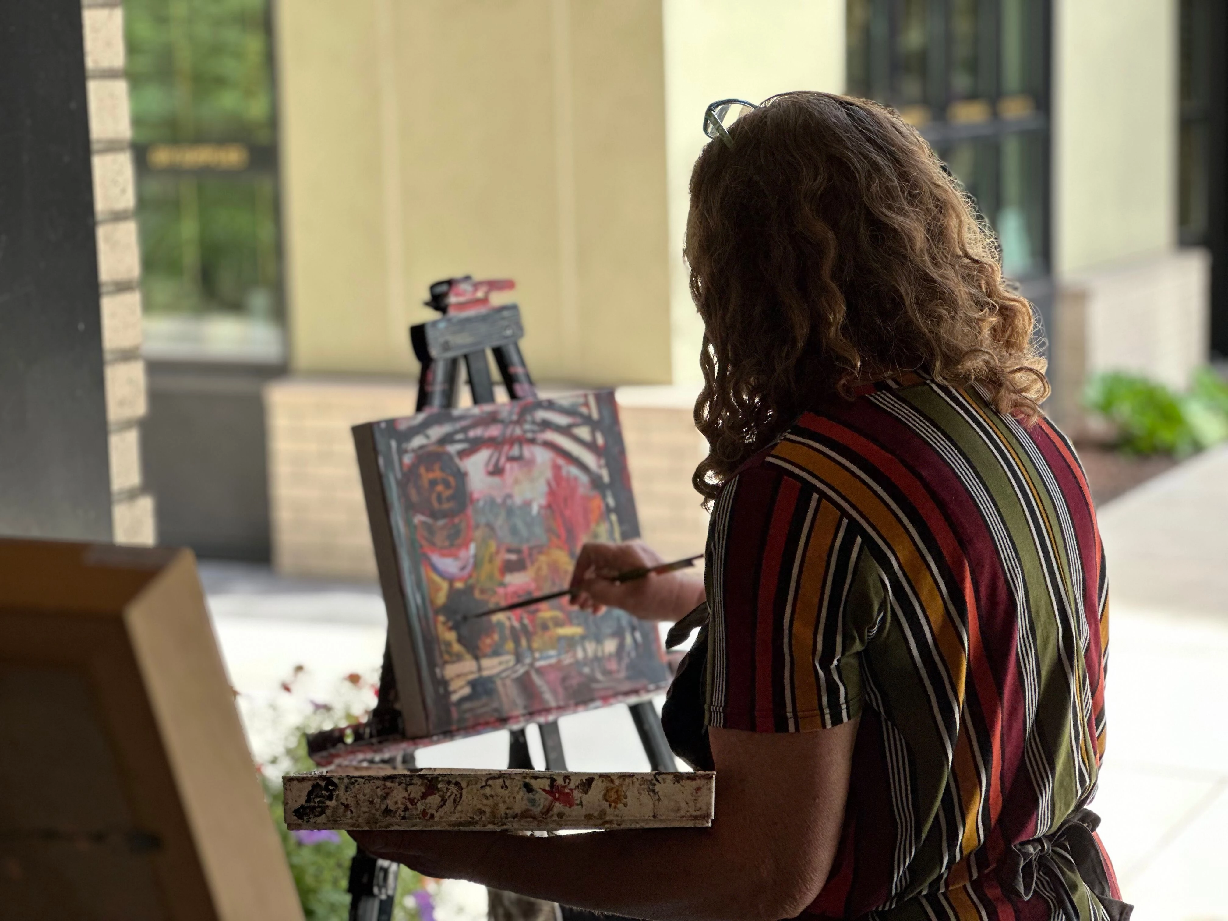 a person painting on an easel