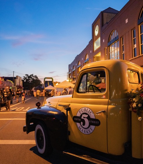 a yellow truck parked on a street