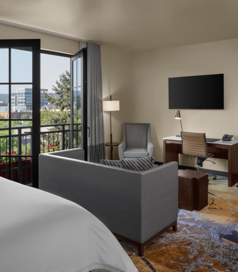 interior view of a one bedroom suite at The Gordon Hotel featuring open juliette doors and both living room areas