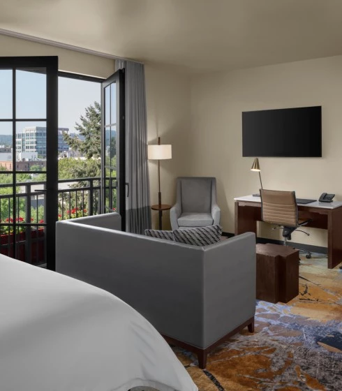 interior view of a one bedroom suite at The Gordon Hotel featuring open juliette doors and both living room areas