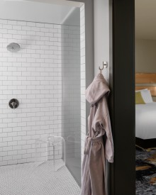 split view of a one bedroom suite featuring bathroom and bedroom at The Gordon Hotel