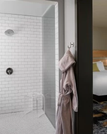 split view of a one bedroom suite featuring bathroom and bedroom at The Gordon Hotel
