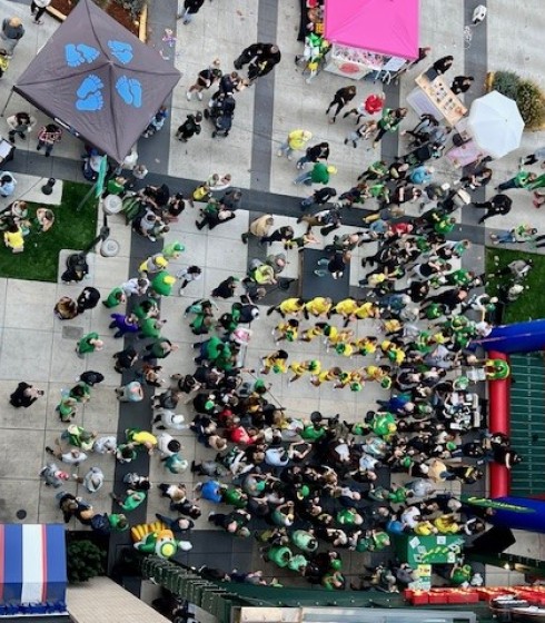 a group of people walking on a sidewalk