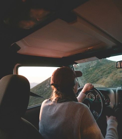 A woman on a road trip enjoying a beautiful view