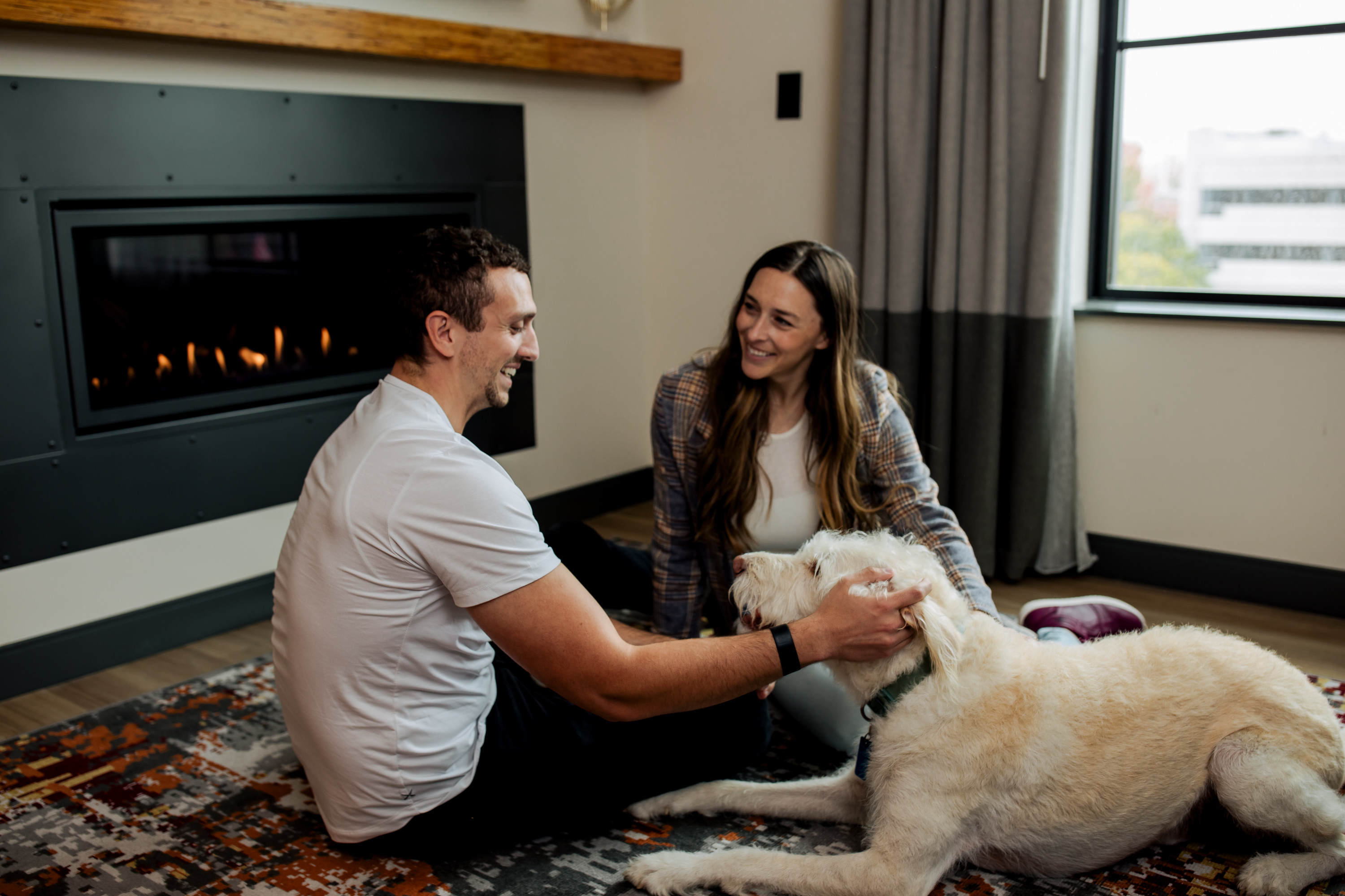 a man and woman petting a dog
