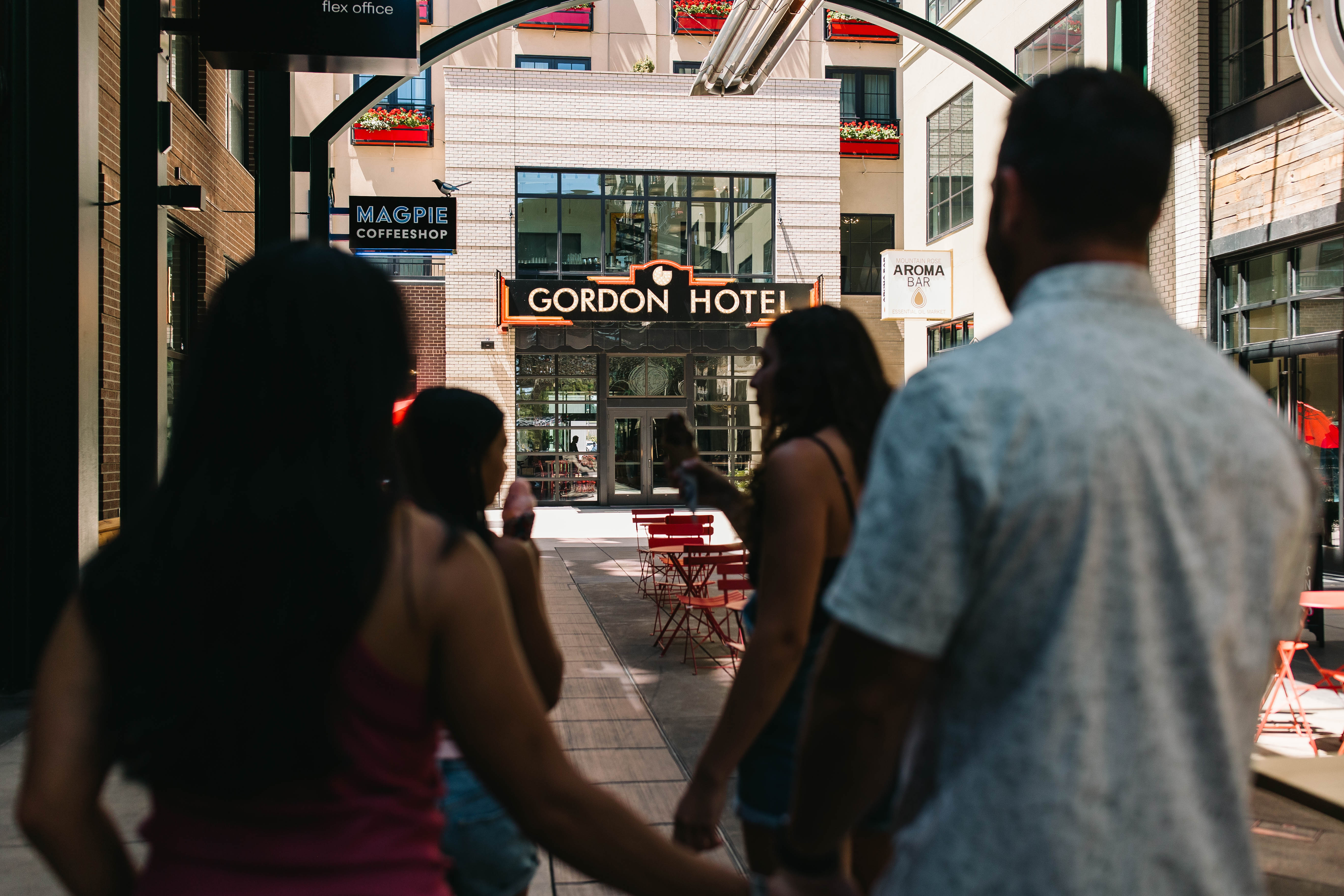 a group of people walking down a sidewalk