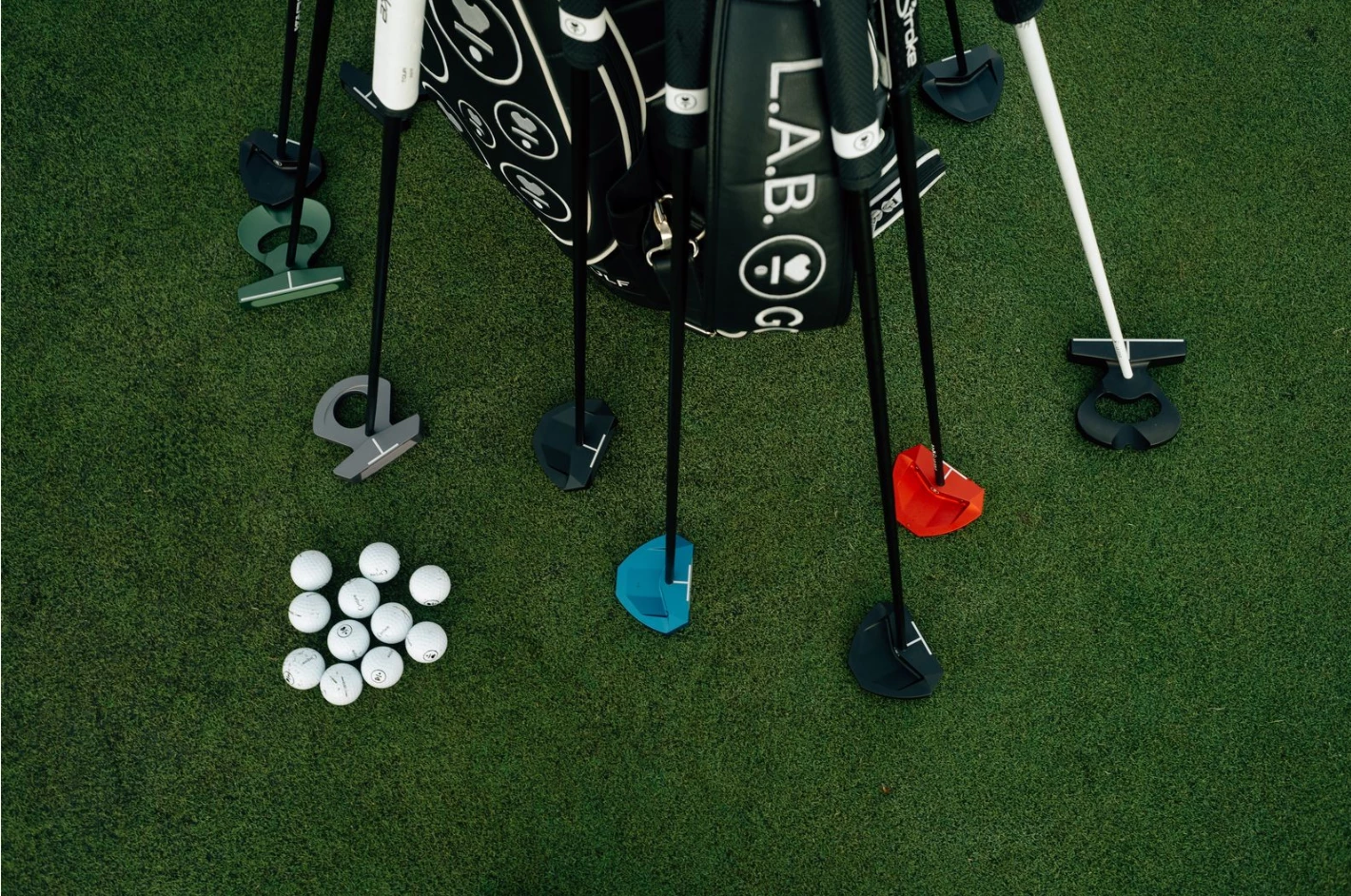 golf clubs and balls on a golf bag