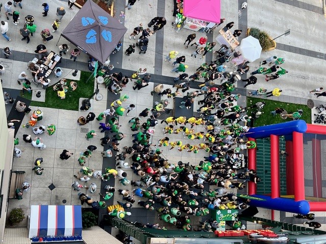 a group of people walking on a sidewalk