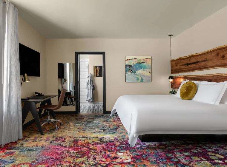 a room with a bed and a desk and chair