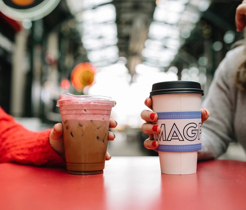a person holding a cup of coffee