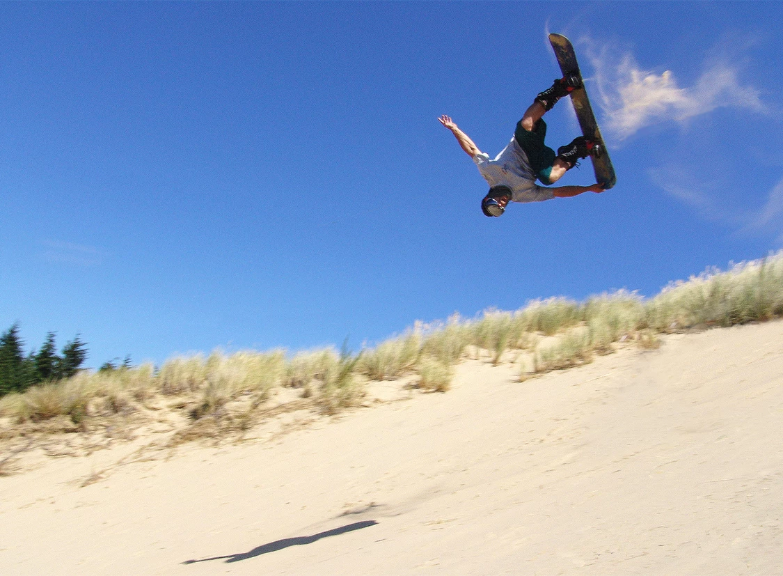 a man doing a trick on a snowboard