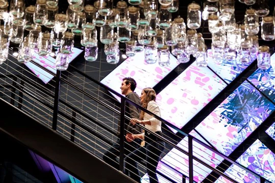 a man and woman walking up a staircase