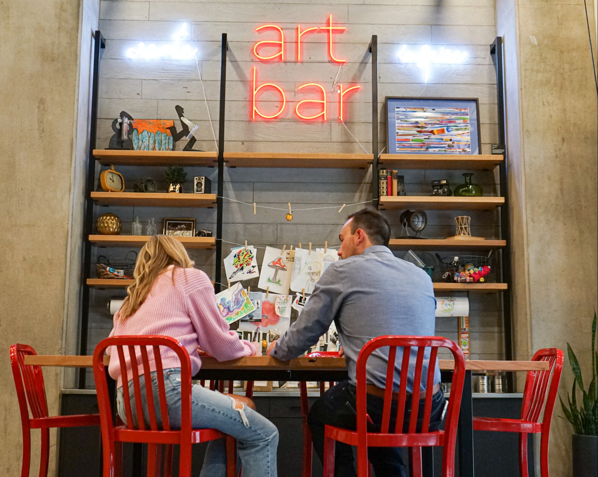 A couple sitting at the Gordon Hotels Art Bar creating art