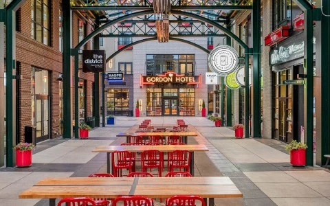 An outdoor market with tables and chairs 