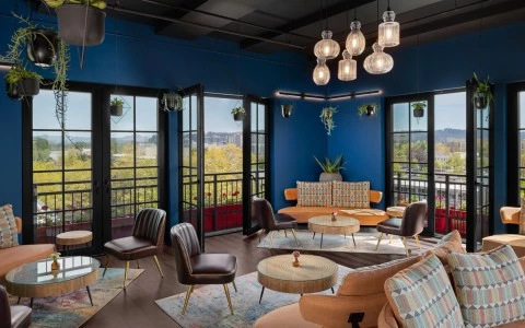 a room with a large glass door and a large patio with chairs