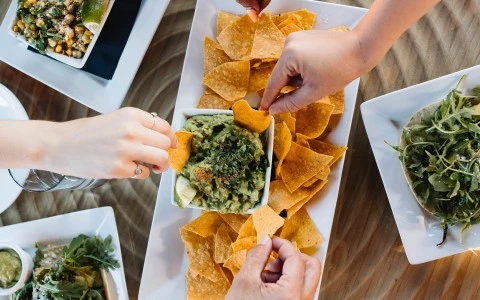 a group of people eating chips