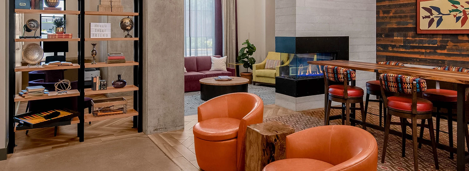 a room with a table chairs and shelves