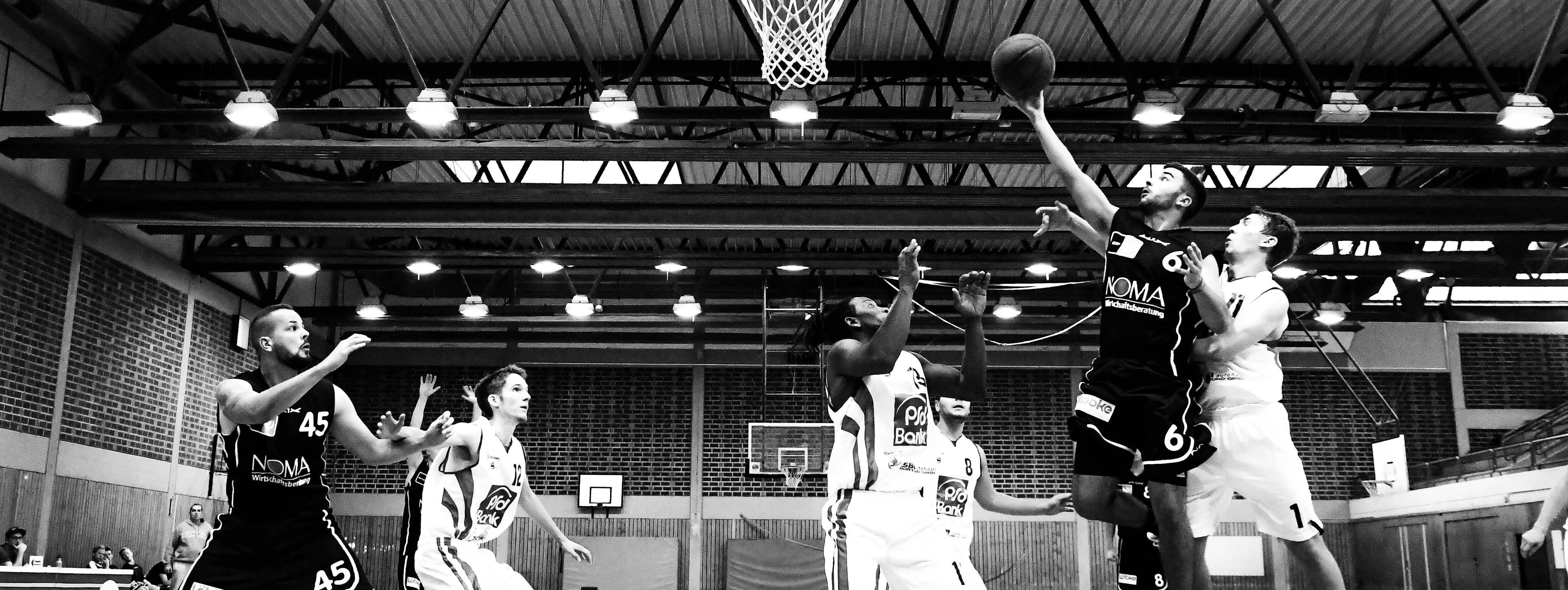a group of men playing basketball