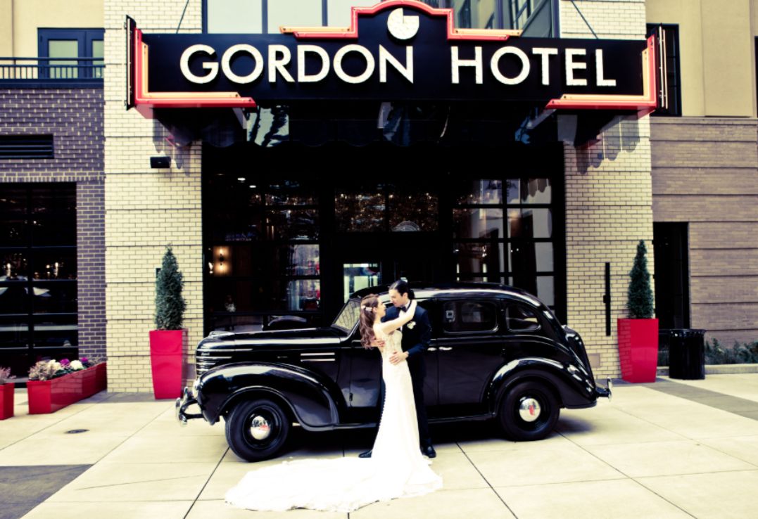 a man and woman in front of a hotel