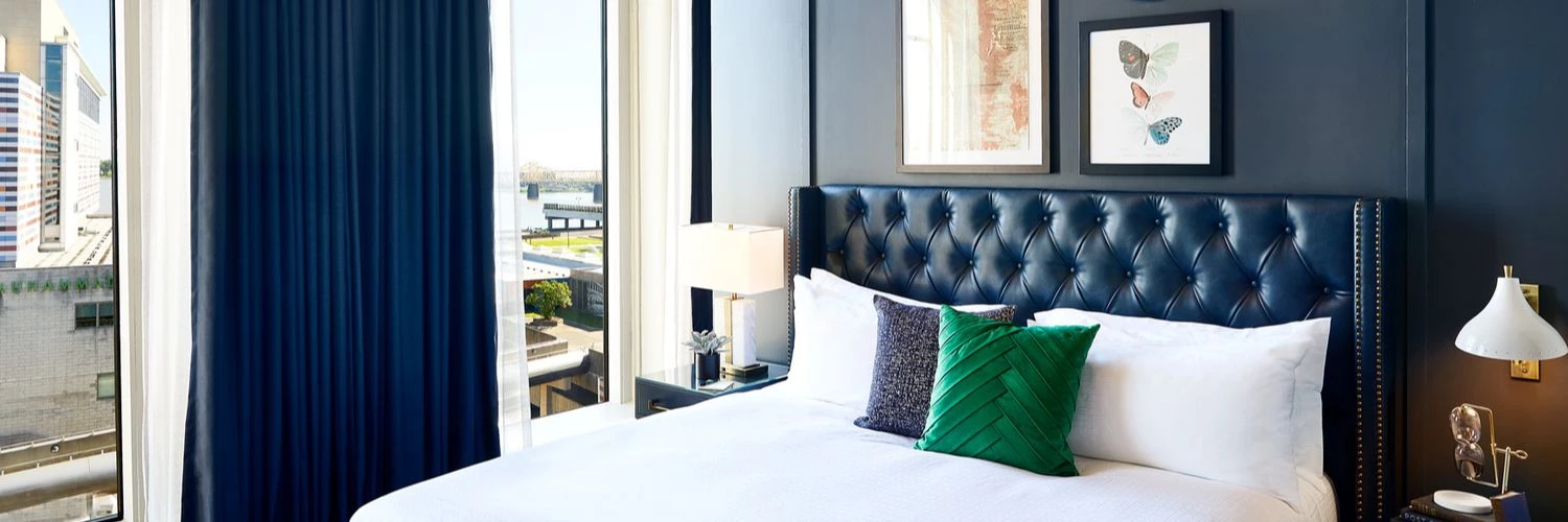 king bed with view and green pillow