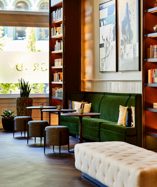 close up view of lobby with green velvet chairs
