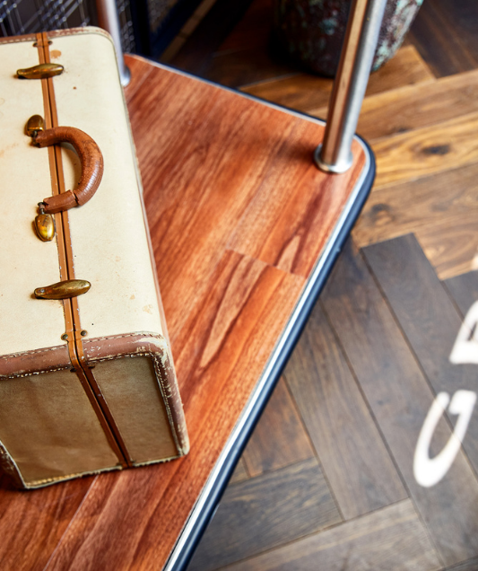 view of a vintage briefcase on a luggage cart
