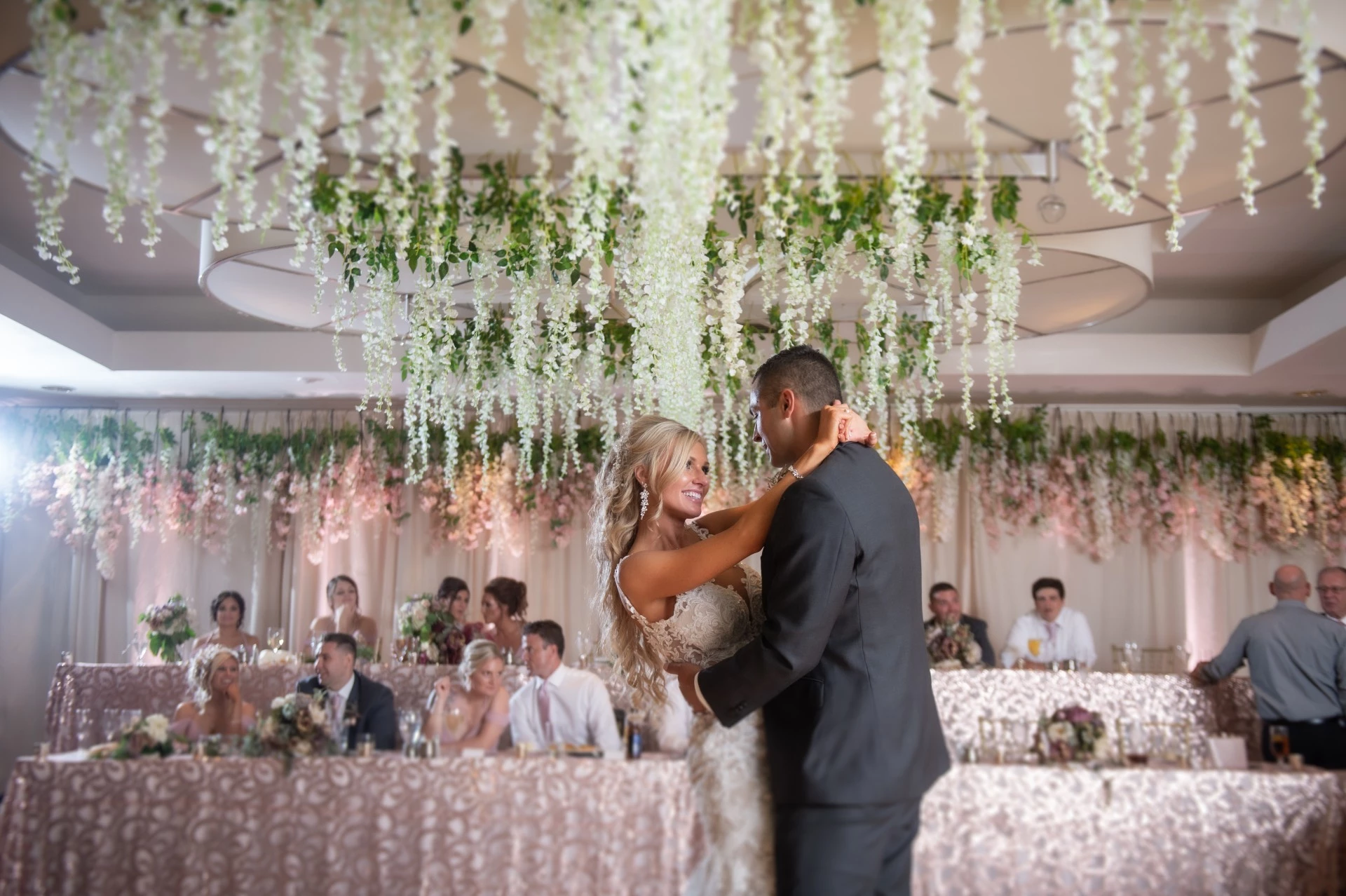 a man and woman dancing in a room with people in the background