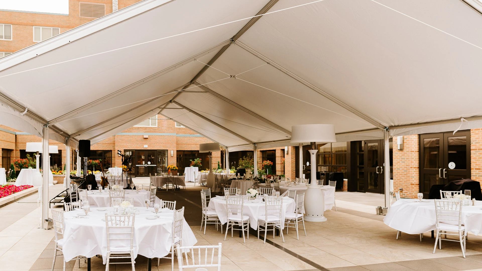 a white tent with tables and chairs