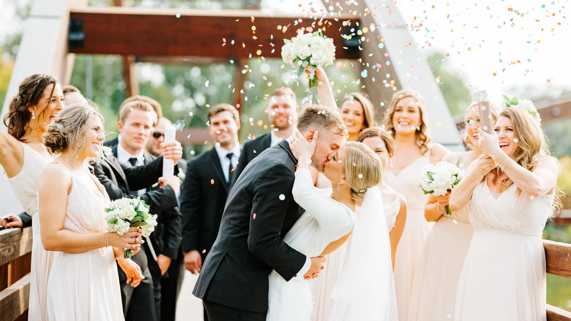a man and woman kissing in front of a group of people