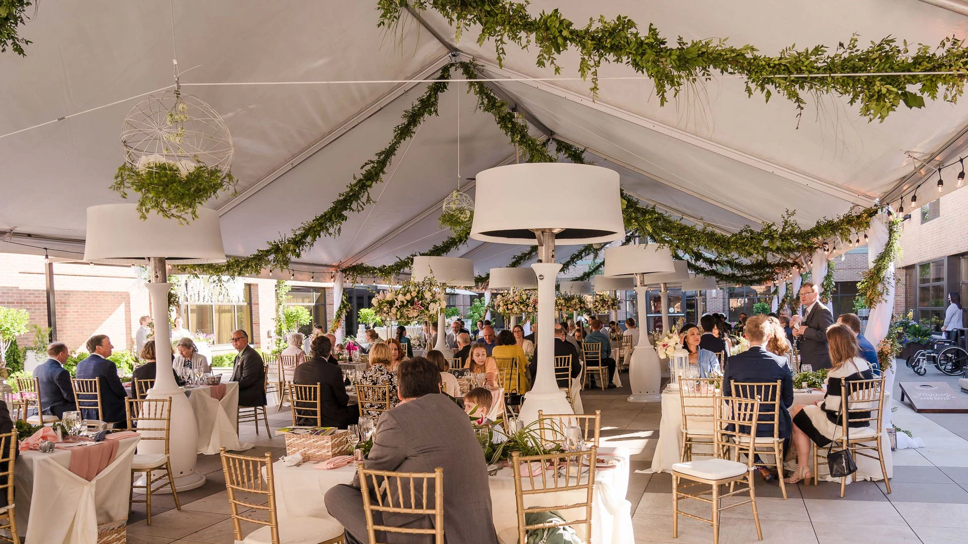 a group of people sitting at tables in a tent