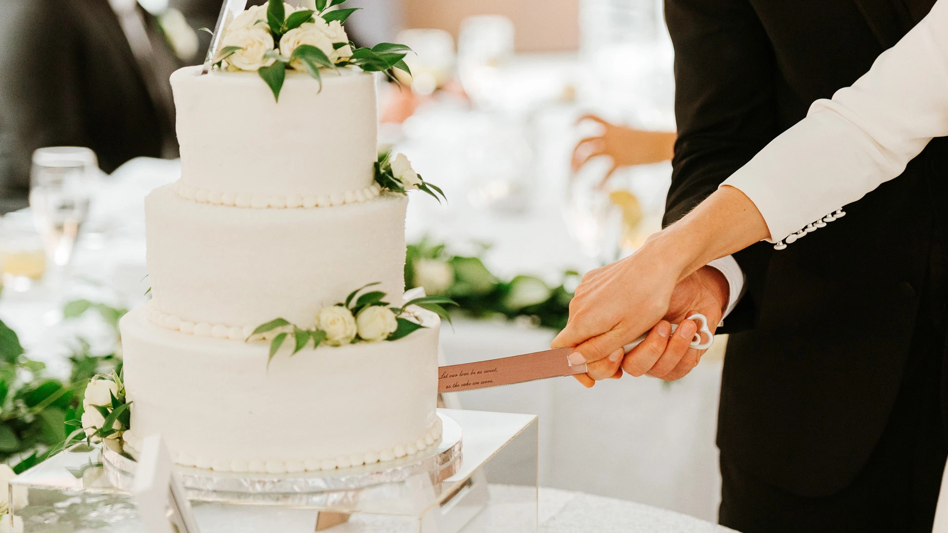 a person cutting a cake