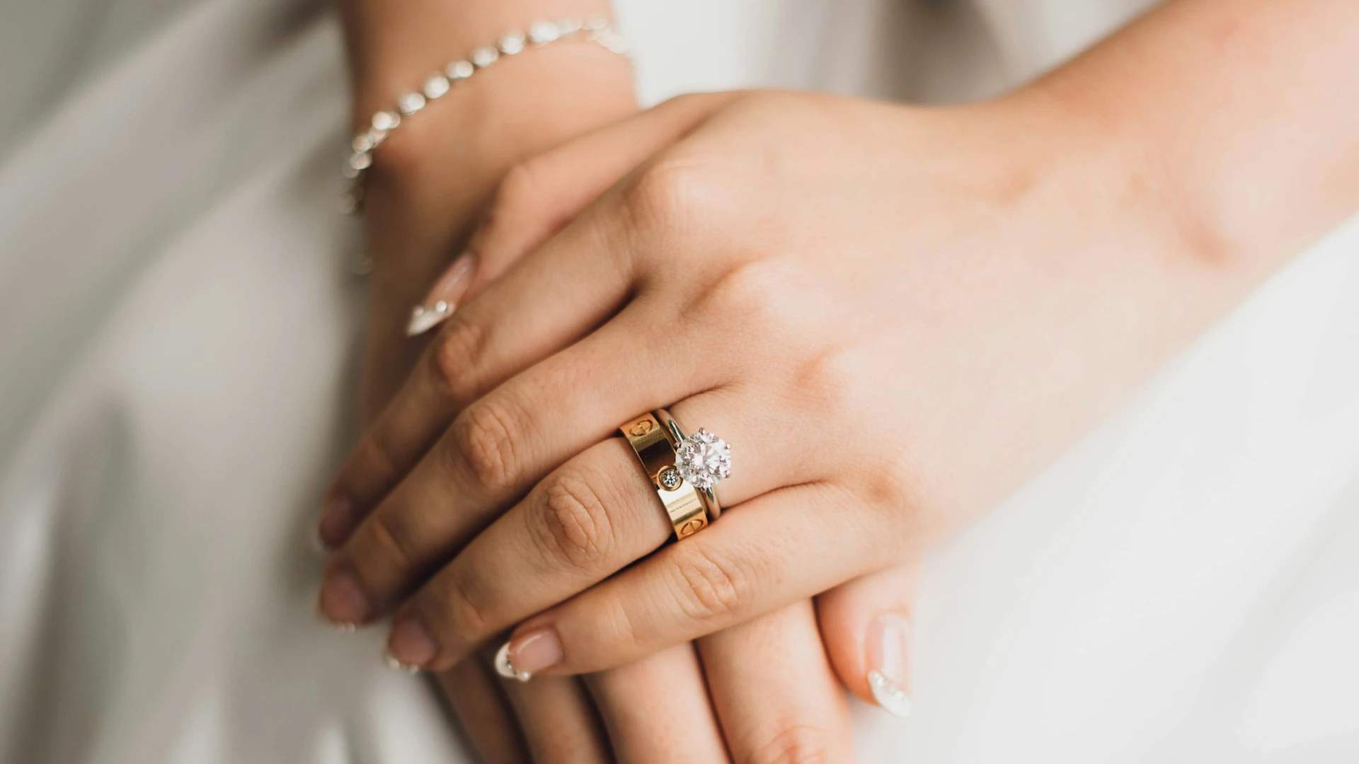 a close up of a woman's hands with a ring on her finger