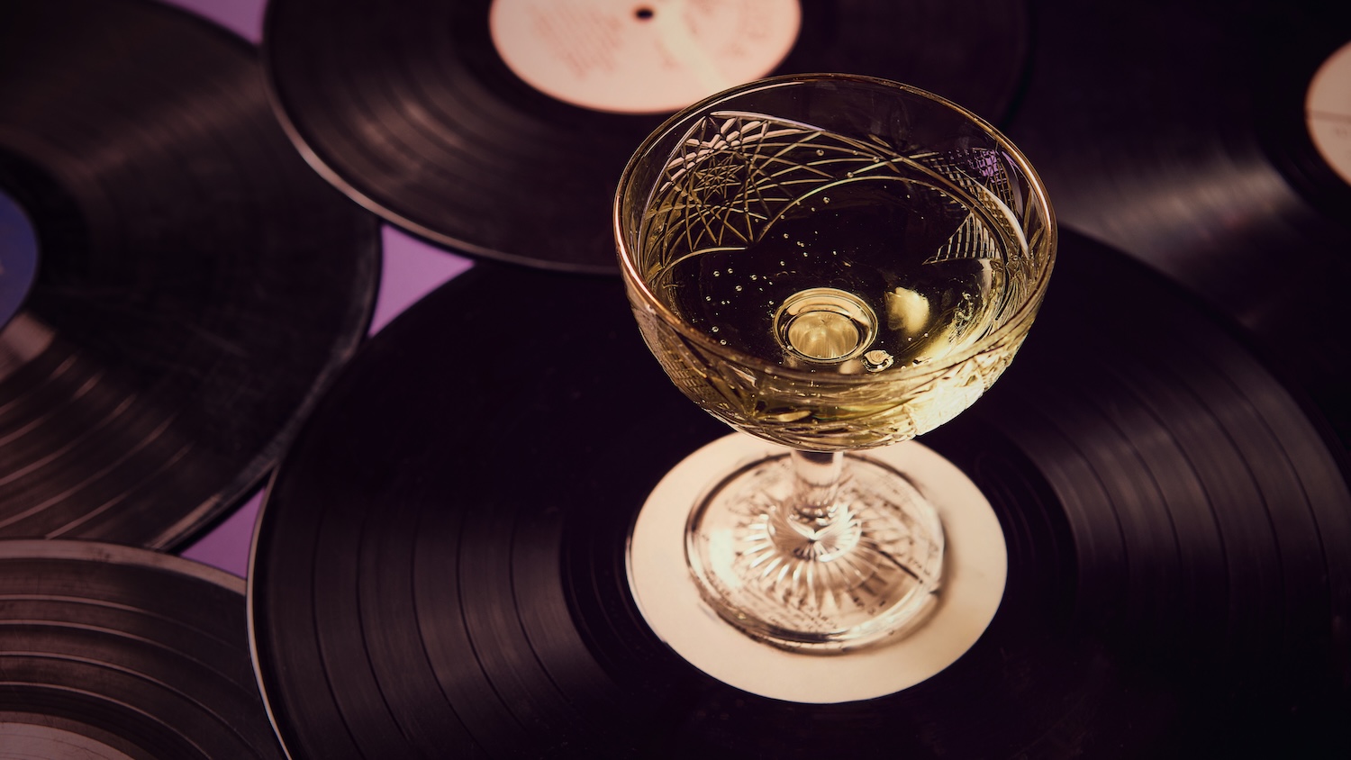 a glass of wine on a record