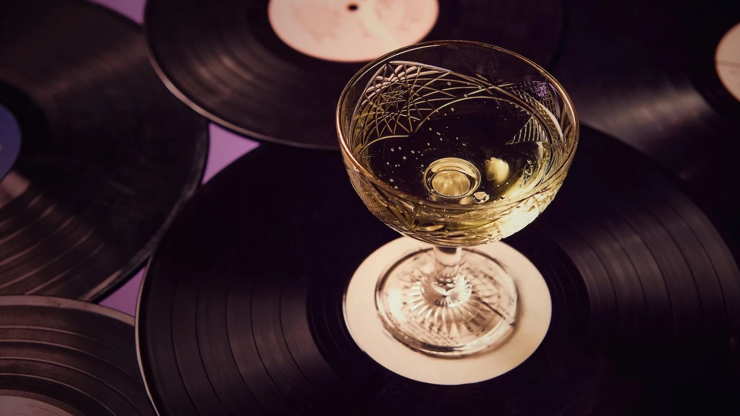 a glass of wine on a record