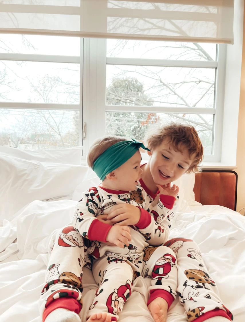 two children sitting on a bed