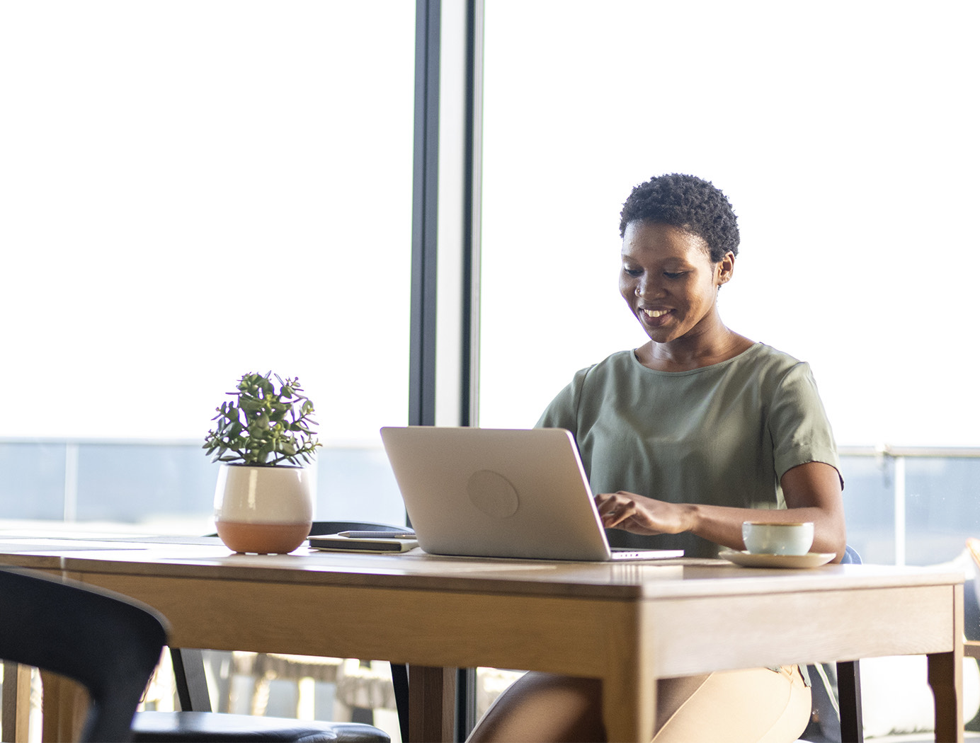 a man sitting at a table with a laptop