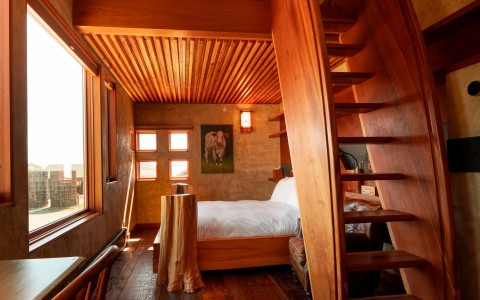 a bedroom with a wooden staircase