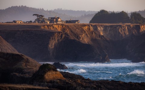 a house on a cliff by the ocean