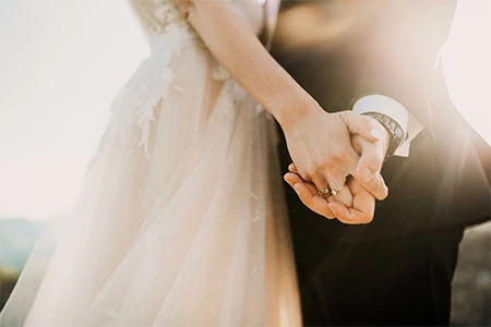 a close-up of a couple holding hands