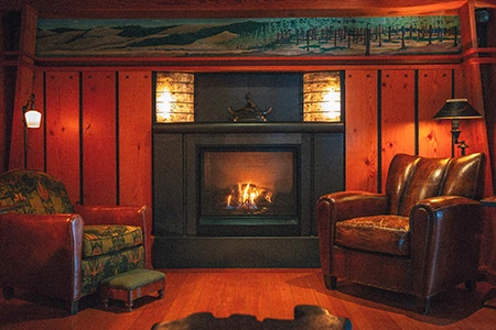 a fireplace with a fireplace and chairs