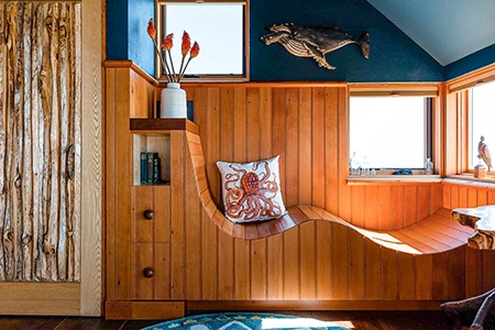 a wooden wall with a window and a pillow on it