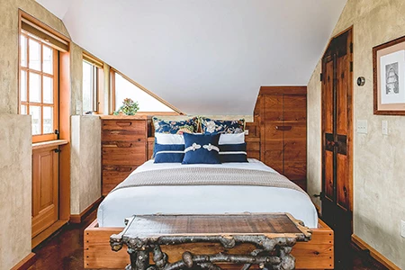 a bed with a wooden headboard and a table