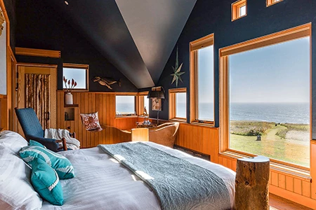 a bedroom with a view of the ocean
