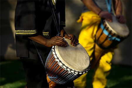 a close-up of a man playing drums