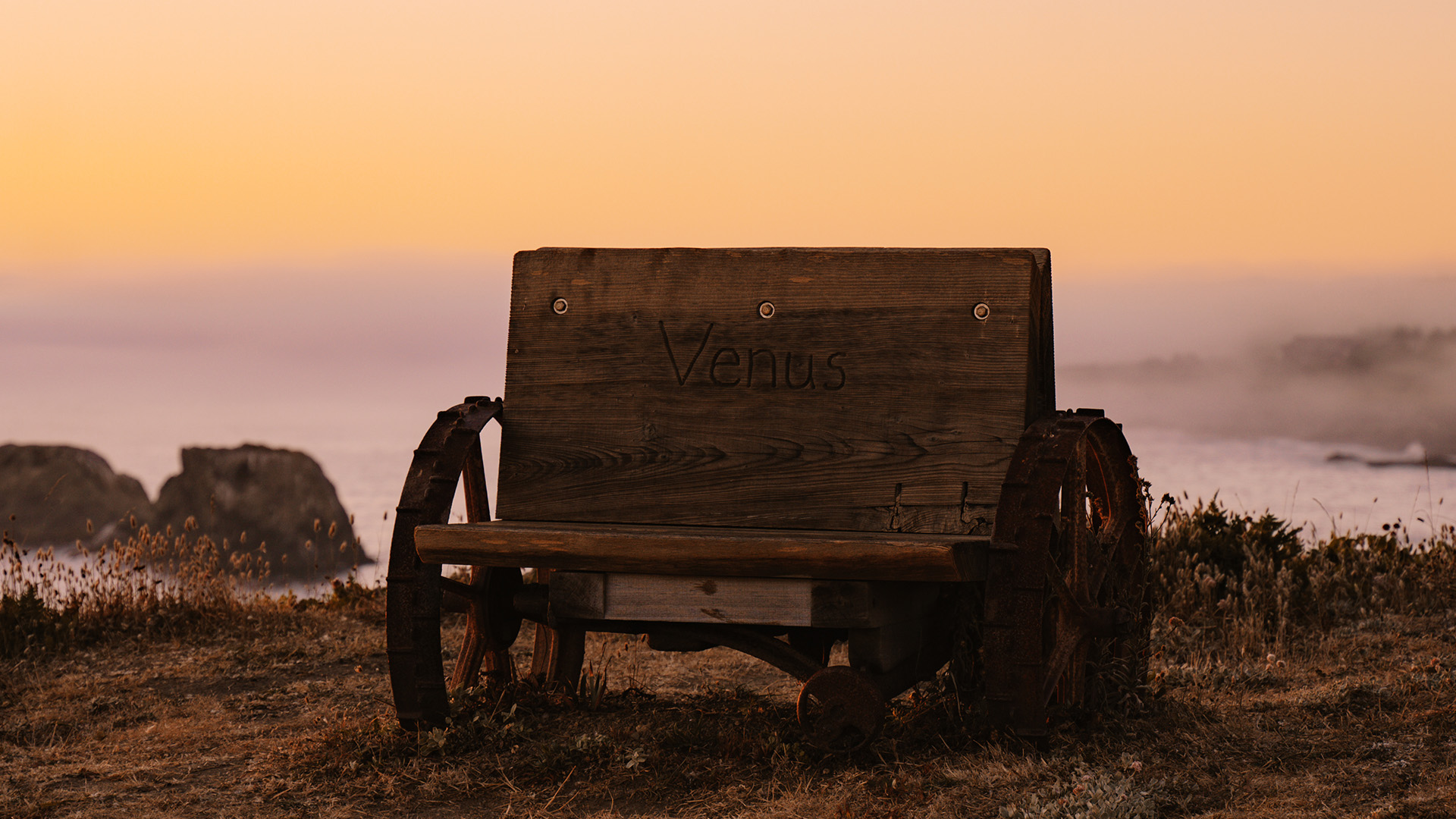 a wooden bench with wheels on it