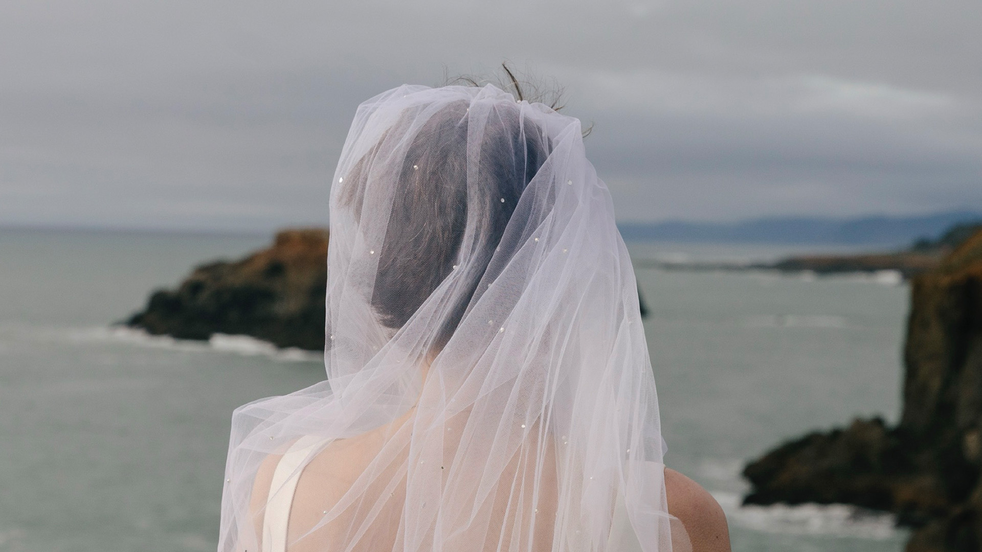 a woman wearing a white dress and a veil
