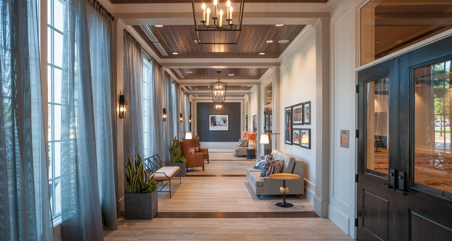 a long hallway with couches and chairs