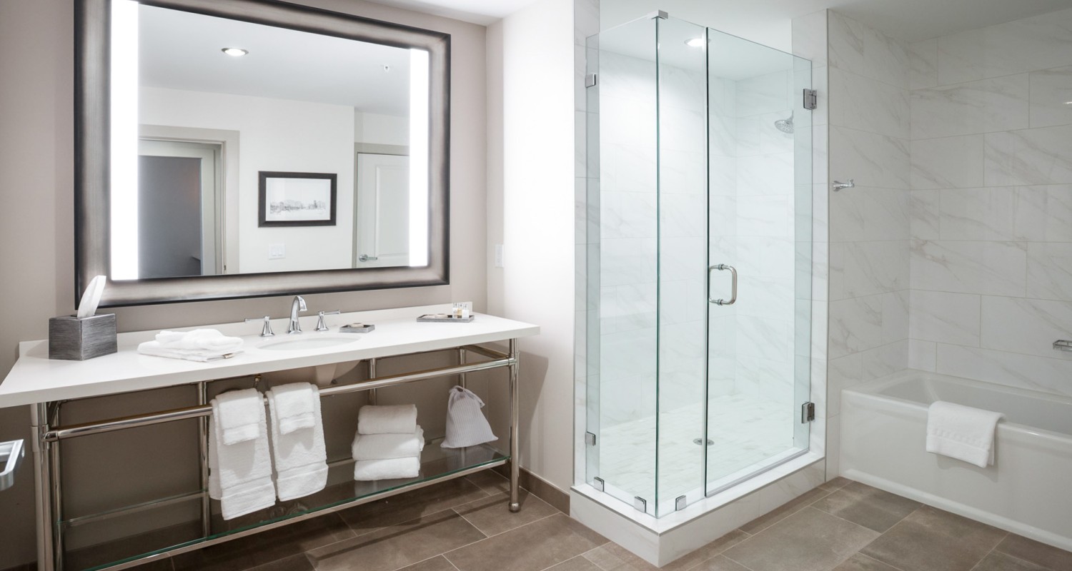 a bathroom with a glass shower and a sink