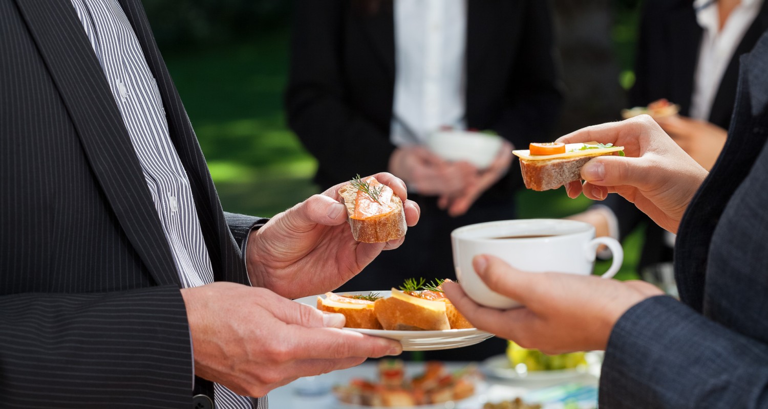 a group of people holding food and a cup of coffee